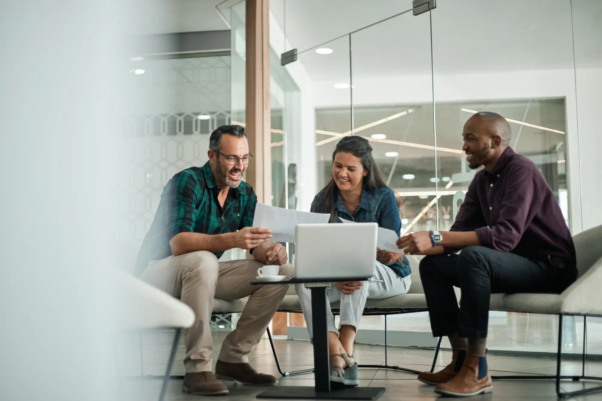 Image of 2 people around a laptop talking with their strategic marketing coach